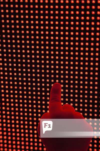 Childs hand touching LED display
