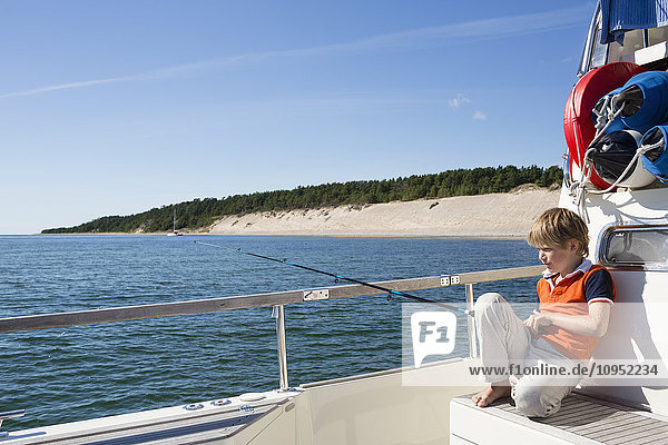 Boy on boat fishing