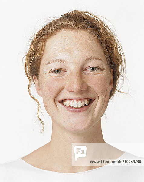 Portrait of smiling red-headed woman.