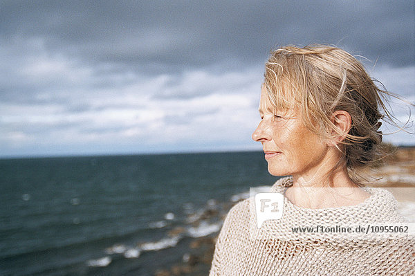 Mature woman looking at sea