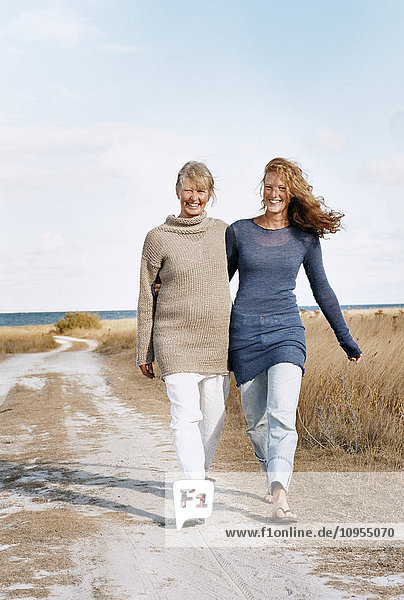 Mother and adult daughter walking together