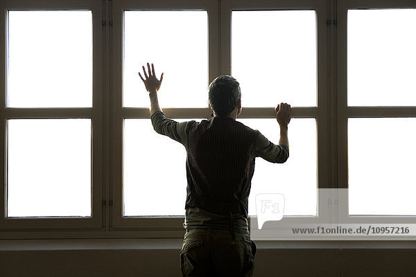 Man standing by a window  Sweden.