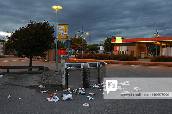 Overfull litterbins on a desert parking lot Sweden.