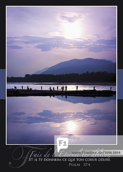 Fischer  die in einer Reihe stehen und sich im Fraser River bei Sonnenuntergang mit französischer Schrift spiegeln; British Columbia  Kanada'.