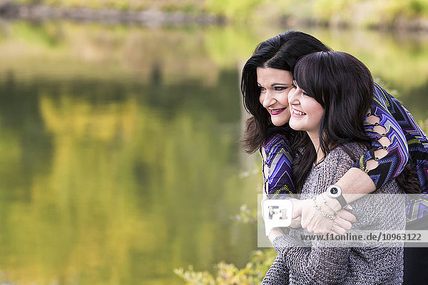 'Mother and daughter spending quality time together in a city park in autumn; St. Albert  Alberta  Canada'