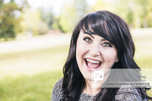 'Portrait of a beautiful young woman outdoors in a park in autumn; St. Albert  Alberta  Canada'
