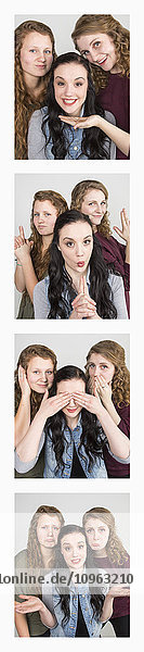 'Three young women creating photo booth series of images in filmstrip format; Alberta  Canada'