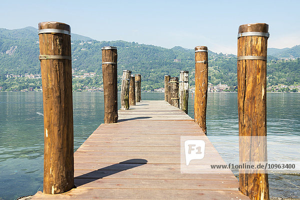'Wooden dock and posts on Lake Orta; Orta  Piedmont  Italy'