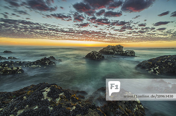 'Red clouds of sunset over the ocean along the coast of South Africa near Hondeklip Bay; Namakwa South Africa'