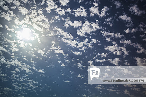 'Cloud scattered in a blue sky with sunlight; Israel'