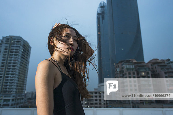 'Young female model on a rooftop in evening  fresh and fashion feeling; Xiamen  Fujian  China'
