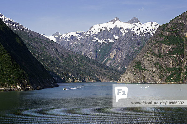 Scenic view of Tracy Arm Fjord with a tour boat heads out  Southeast Alaska  summer