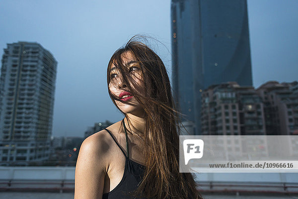 'Young female Chinese model on a rooftop in evening  fresh and fashion feeling; Xiamen  Fujian  China'