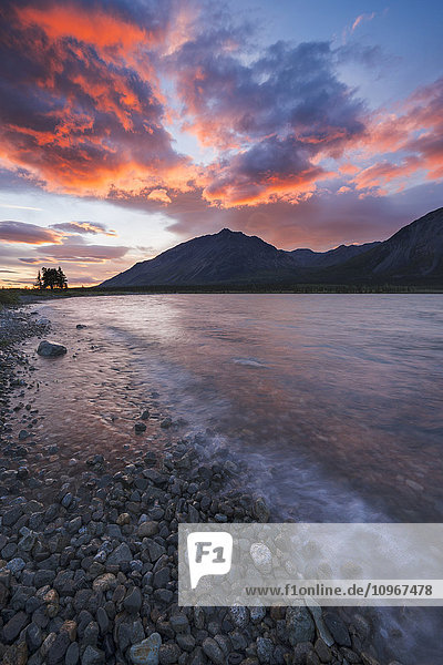 Colors of sunset fill the sky over upper Twin Lake in Lake Clark National Park & Preserve  Alaska.