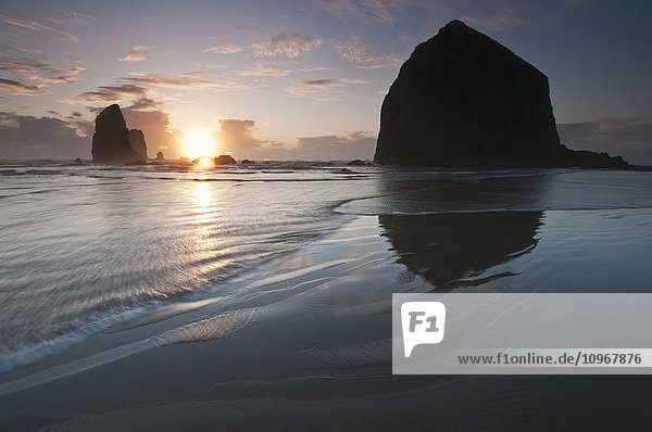 Sonnenuntergang hinter Haystack Rock; Cannon Beach  Oregon  Vereinigte Staaten von Amerika'.