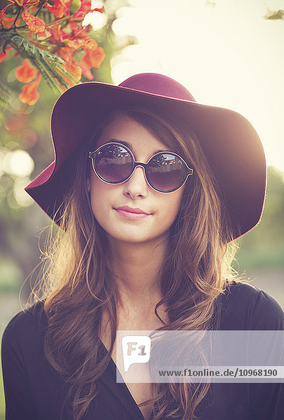 Fashion Portrait of Beautiful Stylish Young Woman in Hat and Sunglasses