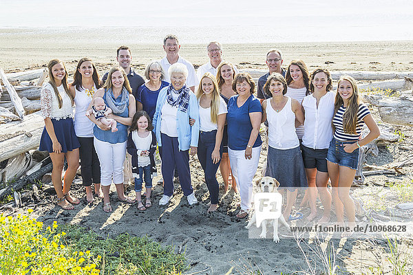 'Portrait of a large family on a beach along the coast; Fox Spit  Whidbey Island  Washington  United States of America'