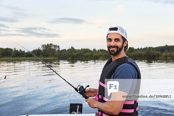 'Man fishing from a boat in Lake Wabamun; Alberta  Canada'