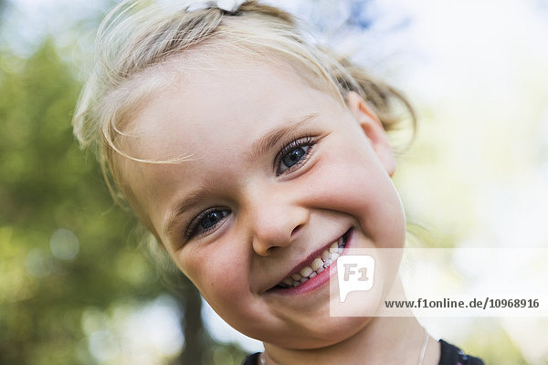 'Portrait of a young girl with a big smile and blond hair; Edmonton  Alberta  Canada'