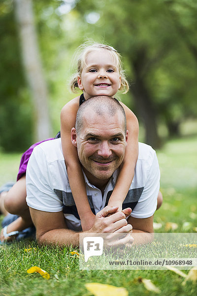 'Father and daughter spending quality time together in a park; Edmonton  Alberta  Canada'