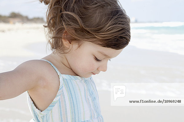 'Young girl on a white sand beach at the water's edge; Varadero  Cuba'