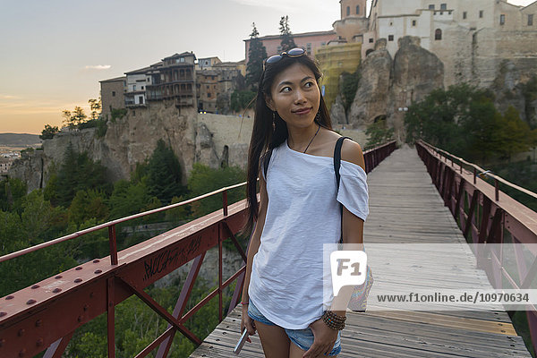 'Young Chinese woman walking around Cuenca's downtown; Cuenca  Castile-La Mancha  Spain'