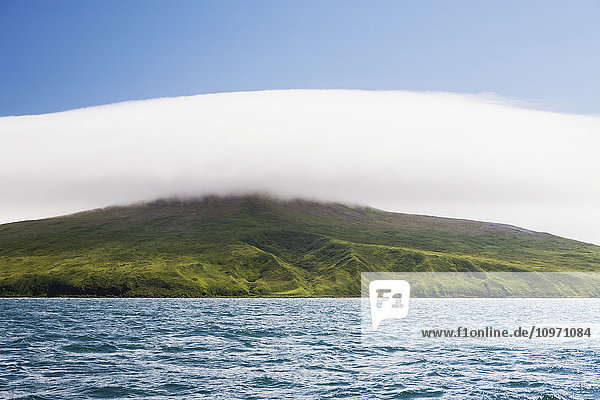 'Clouds Hovering Over Green Shores Near Cold Bay  Alaska Peninsula; Southwest Alaska  United States Of America'