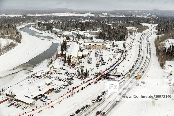 Aerial view of a team leaving the start line at Pikes Landing in Fairbanks  Alaska during the 2015 Iditarod