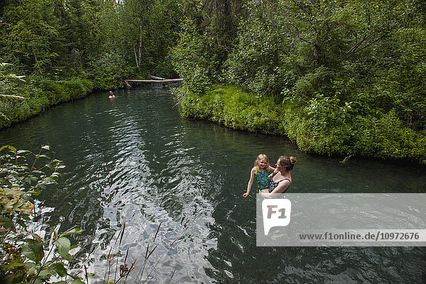 Woman and daughter in Liard Hot Springs  British Columbia  Canada  summer