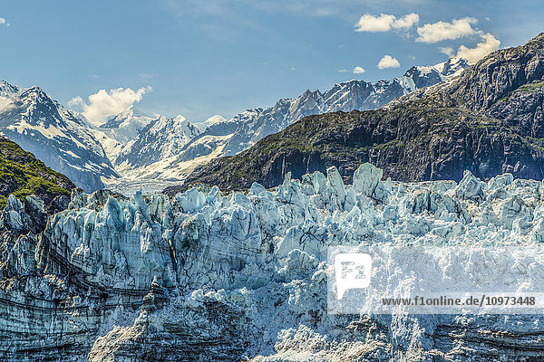 View of face of Margerie Glacier in Tarr Inlet with Fairweather Mountain Range in Glacier Bay National Park  Southeast Alaska