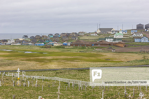 'A weathered picket fence surrounds the grave crosses in the cemetary outside St. Paul St. Paul Island Southwestern Alaska USA Summer'