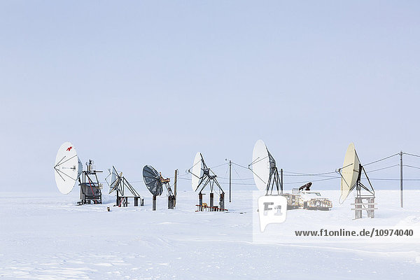 An array of satellite dishes pointing out to the Arctic Ocean  Barrow  North Slope  Arctic Alaska  USA  Winter