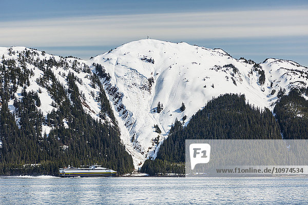 The fast ferry Chenega of the Alaska Marine Highway System motors out of the Passage Canal to Valdez  Prince William Sound  Whittier  Southcentral Alaska  USA  Winter