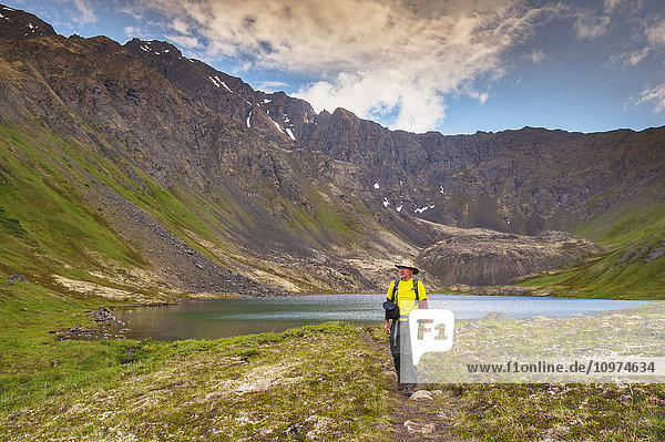 A man hiking in Hanging Valley in South Fork near Eagle River on a summer day in South Central Alaska.