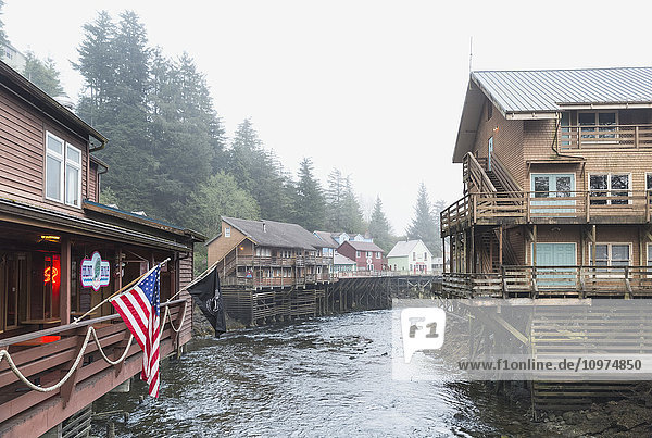 Tourist shops and homes along Creek Street in downtown Ketchikan Southeast Alaska USA Spring