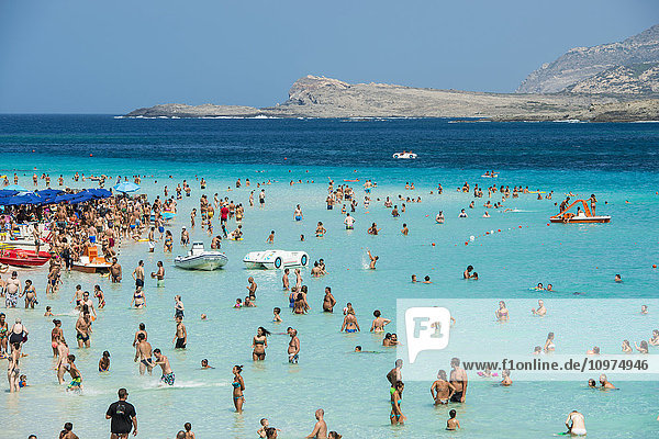 'Tourists enjoying the turquoise waters of famous Pelosa Beach; Stintino  Sardinia  Italy'