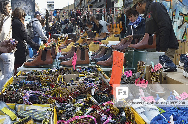 'Shoe stall and accessories at Brick Lane Market  Shoreditch; London  England'
