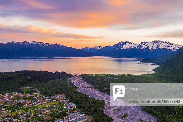 The sunsets behind the Chugach Mountains and colors up the sky over Valdez  Port Valdez and Mineral Creek  Southcentral Alaska  summer
