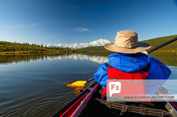 Man kayaking on Wonder Lake with Denali in the background  Interior Alaska  summer