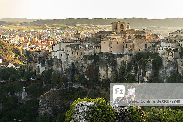 'Two friends having rest in the surroundings of Cuenca with a beautiful landscape behind them; Cuenca Castile-La Mancha Spain'