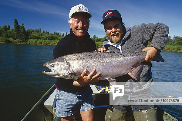 Fisherman & Guide Holding Large King Salmon In Boat Nushagak River Southwest Ak Summer