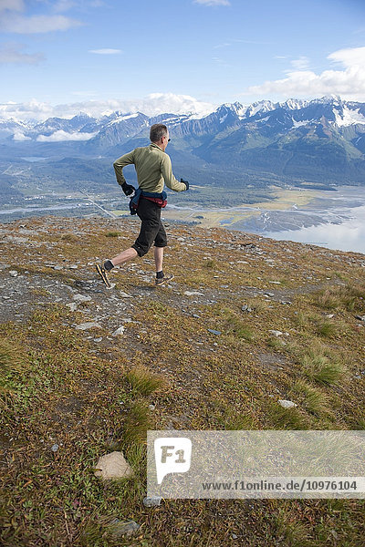 Man descending the upper scree fields of Mount Marathon  Seward  Southcentral  Alaska  summer