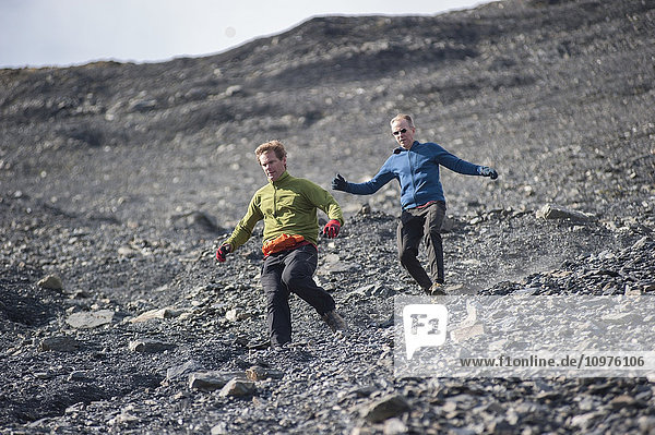Men descending the upper scree fields of Mount Marathon  Seward  Southcentral Alaska  summer