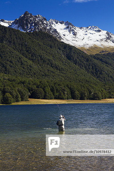 'A man practices fly fishing at Mavora Lake; Mavora  Southland  New Zealand'
