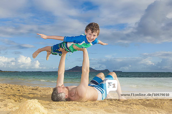 'Father and son playing at the beach; Kailua  Island of Hawaii  Hawaii  United States of America'