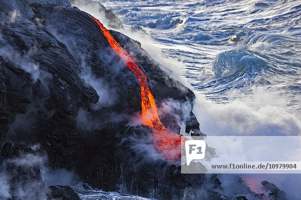 'The Pahoehoe lava flowing from Kilauea has reached the Pacific ocean near Kalapana; Island of Hawaii  Hawaii  United States of America'