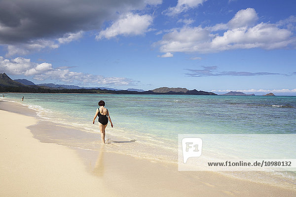 Eine Frau geht am Strand entlang  Kaiona Beach Park; Waimanalo  Oahu  Hawaii  Vereinigte Staaten von Amerika'.