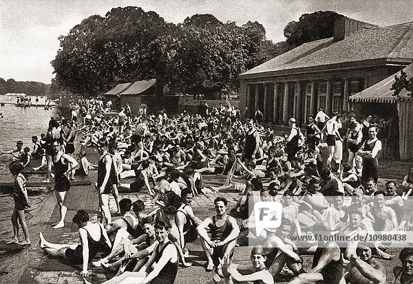 'Crowds of people at the Lansbury ''Lido'' at the Serpentine in Hyde Park  London  England in 1930. From The Story of 25 Eventful Years in Pictures published 1935'
