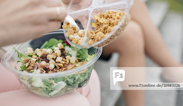 Woman having lunch break with salad outdoors