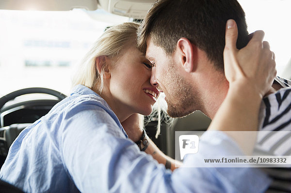 Couple in love kissing in a car